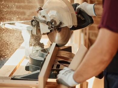 Cutting timber with a mitre saw in a workshop